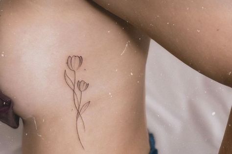 Tulip Side Tattoo, Tulip Tattoo Side Rib, Tulip Spine Tattoos For Women, Dainty Flower Tattoos, Wrist Tattoos Words, Minimal Tattoo Ideas, Thumb Tattoos, Flower Spine Tattoos, Tulip Tattoo