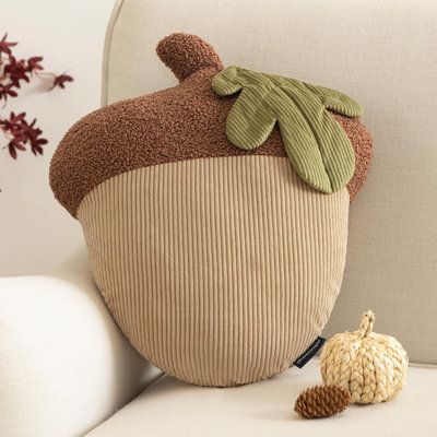 Bring the warmth and joy of autumn into your home with this delightful pillow, designed to brighten up your leisurely fall days. | Unkoma Acorn Shaped Throw Pillow, Fun Home Decor of Fruit Themed Shaped Cushions Polyester / Polyfill Blend in Acorn Brown | 18" H X 15" W X 5" D | Wayfair Thanksgiving Throw Pillows, Cute Fall Pillows, Fall Pom Pom Garland, Acorn Fall Decor, Cozy Fall Decor Diy, Primitive Thanksgiving Decor, Homemade Fall Decorations, Acorn Pillow, Pie Pillow