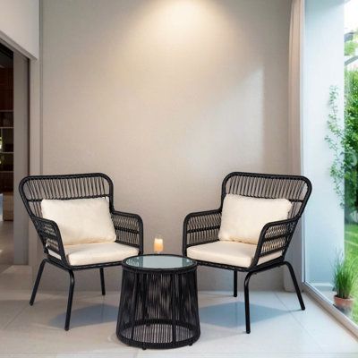 This Outdoor Wicker 3 Piece Bistro Set includes 2 chairs and a matching table with tempered glass top, made from rust and water-resistant PE rattan and powder-coated steel. it offers you a quiet, cozy space outdoors for any garden, patio, front porch, backyard. | Bay Isle Home™ Dawna 3 Piece Seating Group w/ Cushions black | Outdoor Furniture | C004921975_1950826025_1950826027 | Wayfair Canada Front Of House Seating Ideas, Balcony Furniture Apartment, Small Porch Seating Ideas, Garden Chairs Ideas, Front Patio Furniture, Front Porch Chairs Ideas, Black Wicker Patio Furniture, Black Sofa Decor, Porch Furniture Ideas