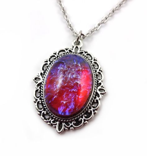 PRICES MAY VARY. This necklace is exquisite - the main focal point is the 18x25mm red blue glass cabochon. It has been set in an ornate silver oval Victorian style setting and comes with a matching 18 inch traditional style link chain with lobster clasp. GLOWS IN THE DARK! Use the included UV flashlight to "charge" the glow. See below for further information. Theme: Fairy Tale, Fantasy, Once Upon a Time, Role Play, Theme Weddings, etc! Mexican Fire Opal Dragon's Breath glass cabachon - Colors sh Opal Necklace Pendant, Dragons Breath Fire Opal, Dragons Breath Opal, Blue Pendant Necklace, Mexican Opal, Dragon Fire, Fire Opals Jewelry, Blue Fire Opal, Red Opal