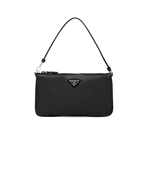 Characterized by a sleek line and emphasized by the iconic enameled metal triangle logo, this pouch is made of Prada's innovative Re-Nylon fabric produced from recycled plastic materials collected in the ocean. The accessory has a leather strap that lets you also wear it over the shoulder. Prada Nylon Mini Bag, Prada Mini Bag, Prada Nylon Bag, Prada Mini, Best Designer Bags, Bag Prada, Girly Bags, Trendy Handbags, Dry Cleaners