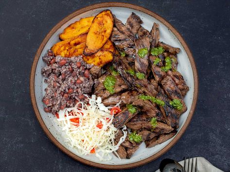 This grilled skirt steak—a beloved staple at Nicaraguan fritangas—is infused with the bittersweet flavor of Seville oranges. Find the recipe here. Essen, Nicaraguan Recipes, Nicaraguan Food, Carne Asada Recipes, Grilled Skirt Steak, Marinated Flank Steak, Herb Salad, Marinated Beef, Ribs On Grill