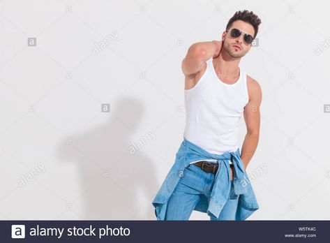 Download this stock image: sensual young man in undershirt posing while holding neck and standing in spotlight on white background, portrait picture - W5TK4C from Alamy's library of millions of high resolution stock photos, illustrations and vectors. Guy Scratching Neck Pose, Scratching Neck Pose, Holding Neck Pose, Holding Neck, White Background Portrait, Background Portrait, Art Help, Portrait Pictures, Pose References