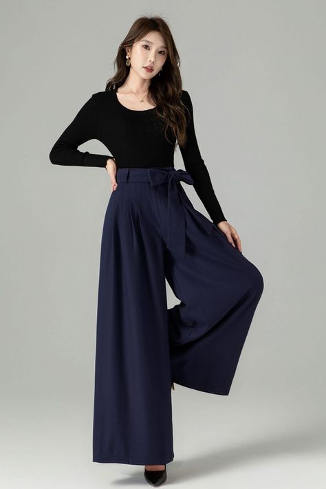 Experience the fusion of comfort and elegance with these navy blue wide leg trousers. Made from high-quality wool, they promise warmth and a soft touch. Perfect for a sophisticated work outfit or match them with a snug sweater and boots for a stylish, relaxed ensemble.  DETAIL * 30% wool, 30% fiber, 40% polyester * polyester lining * Two seam pocket * Belted pants * Front zipper and buttons closure * Wide leg pants, Pleated pants * Perfect forSpring, autumn, and winter * Wash by hand or machine Navy Pleated Pants Outfit, Navy Wide Pants Outfit, Navy Blue Wide Leg Pants Outfits, Elegant Blue Wool Pants, Navy Wide Leg Pants Outfit, Wide Leg Pants With Boots, Blue Wide Leg Pants Outfit, Evening Wool Wide-leg Pants, Tailored Blue Wide-leg Pants