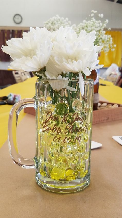 Filled beer mugs with yellow water marbles and filled them with real flowers. Made custom labels for each mug as well. #babyshower #favors #decorations #party Beer Mug Centerpiece Table Decorations, Beer Mug Centerpiece, Rodeo Birthday Parties, A Baby Is Brewing, Baby Is Brewing, Rodeo Birthday, Beer Cup, Baby Shower Party Favors, Decorations Party