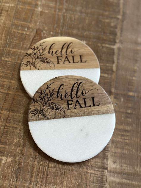 Coasters are a necessity for every home. Yours should reflect your style. Our wood and white coasters can be engraved to do just that: our sunflower coasters add a fall flair to any tabletop. Marble and wood Please note: Marble is a natural product. Variations in color, and texture, plus noticeable cracks and flaws are to be expected as that is the nature of the product Each coaster may be different in marbling and wood color. Measures 4" x 4" Wipe clean Includes foam bottom pads to protect furniture Imported Riser sold separately Style Coasters Finish Hello Fall Sunflower Dimensions 4 x 4 Design Marble and wood Please read our FAQ page prior to purchasing. Install the included handles and use a barrier between our tiered tray and food. Engraved Coaster Ideas, Wood Burned Coasters Diy, Wood And Epoxy Coasters, Coaster Engraving Ideas, Wood Coaster Art, Wood Coaster Ideas, Wood Burn Coasters, Wood Burning Coasters, Wooden Coasters Diy