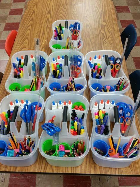 Just made art bins for every art table. Bins are shower caddies from walmart $2.67. The plastic cups came from dollar tree store in a set of 6. It took 2 hours to replace everything, and refill glue bottles but definitely worth the organization for all of my junior high students. Art Table Organization Kids, Table Trash Bins Classroom, Kindergarten Classroom Tables, Table Bins For Classroom, Class Supplies Organization, Desk Caddy Classroom, Table Supply Organization Classroom, Art Classroom Storage Ideas, Classroom Caddy Organization