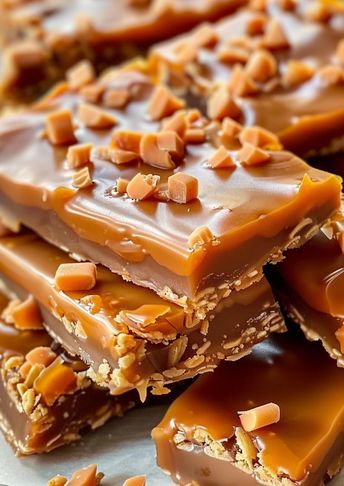 These Butterfinger Caramel Crunch Bars combine layers of caramel, chocolate, and crushed Butterfinger candy on a graham cracker crust. With just 10 minutes of prep, this easy dessert is perfect for holidays, parties, or anytime you need a sweet treat! Rich, crunchy, and full of flavor, these bars will be a hit with friends and family. Save this pin and try them out today! 🍫🍬 Bomb Bars Dessert, Butterfinger Caramel Crunch Bars Recipe, Butterfinger Caramel Crunch Bars, Christmas Bars And Squares, Dessert For Party, Butterfinger Bars, Crunch Bars Recipe, Desert Bars, Butterfinger Candy