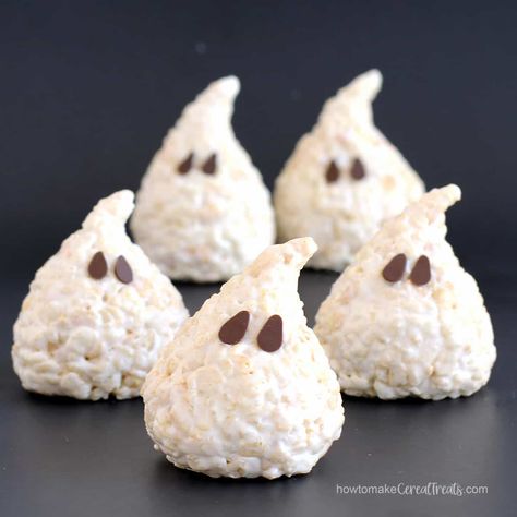 Turn white chocolate Rice Krispie treats into adorably cute ghosts for Halloween. These marshmallow cereal treats are easy to make using just five ingredients. Rice Krispie Treat Halloween Ideas, Halloween Snacks Rice Krispies, Skeleton Rice Crispy Treats, Halloween Desserts For Kids Party, Rice Crispy Pumpkin Treats, Halloween Food Ideas Rice Krispies, Marshmellow Ghost Treats, Halloween Rice Krispie Treats Recipes, Mummy Rice Crispy Treats