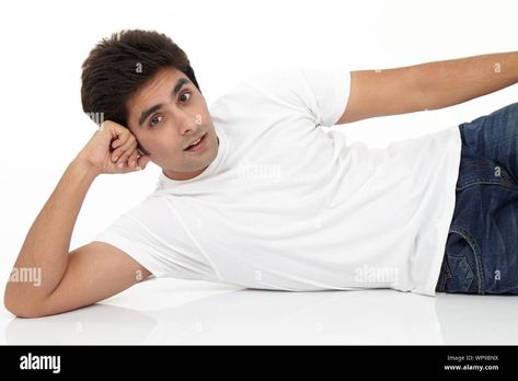 Download this stock image: Young man lying on side on the floor - WP9BNX from Alamy's library of millions of high resolution stock photos, illustrations and vectors. Laying Down On Side Pose, Lying On Side Pose Reference, Lying On The Floor Reference, Person Lying On The Floor, Lying Pose Drawing, Lie Down Pose, Laying On Side Pose, Laying On Side Pose Reference, Lying Poses