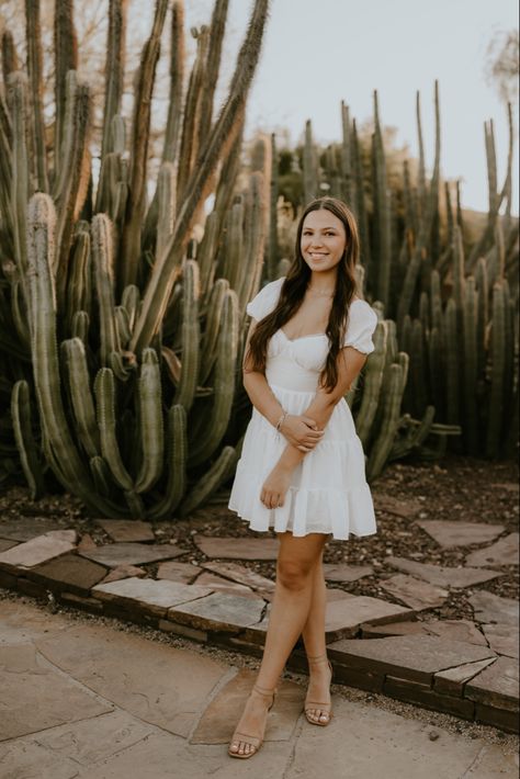 senior pictures with cactus in the background in phoenix arizona at the desert botanical gardens Desert Photoshoot Poses, Mexico Senior Pictures, Cactus Senior Pictures, Senior Pictures Mexican, Senior Picture Ideas Mexican, Desert Graduation Pictures, Mexican Senior Pictures, Arizona Graduation Pictures, Graduation Pictures Desert