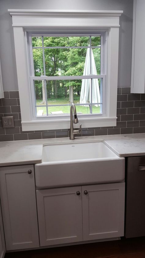 Cloud grey glass subway tile around window. Faucet is by Moen. White Subway Tile Kitchen Backsplash Around Window, Subway Tile Kitchen Window, Backsplash Ideas Around Kitchen Window, Kitchen Sink Backsplash With Window, Subway Tile Around Window, Kitchen Backsplash Around Window, Kitchen Window Backsplash, Kitchen Window Trim, Backsplash Around Window