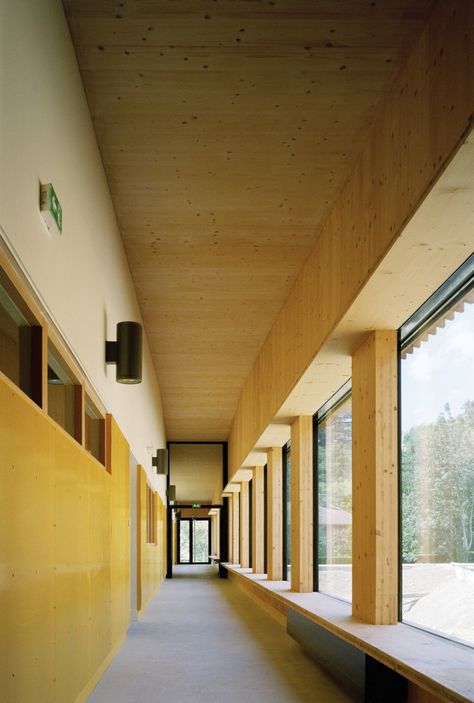 School complex in Rillieux-la-Pape / Tectoniques Architects. Nice window ledge/seats. Corridor Design, Wooden Facade, School Hallways, Kindergarten Design, School Interior, Window Benches, School Building, Yellow Walls, Learning Spaces