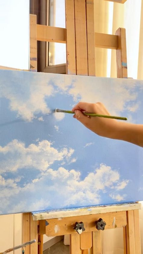 When I painted this painting, I want to show the harmonious beauty of the blue sky and the cloud. I used a light blue base colour to depict the blue sky, while the clouds were painted with white and grey paint. I used different brush atroked and colours in order to recreate the clouds innature as much as possible and to make them look more realistic. Clouds With Watercolor, How To Paint Clouds, Minimal Tattoo Designs, Minimal Tattoo Ideas, Painting Sky, Sky Art Painting, Canvas Painting Tutorials, Grey Paint, The Blue Sky