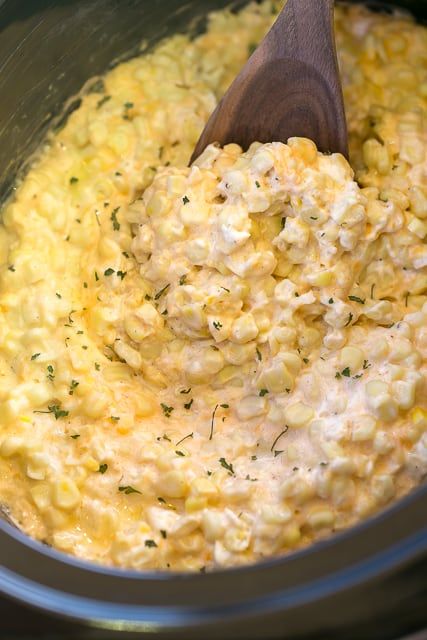 Slow Cooker Cheddar Corn - this stuff is AMAZING!! Just dump everything in the slow cooker and let it work its magic! Frozen corn, cream cheese, cheddar cheese, butter, heavy cream, salt and pepper. Great side dish for a potluck! There is never any left! Such an easy side dish recipe!! Corn Cream Cheese, Cheddar Corn, Corn Cream, Cheese Cheddar, Corn Dishes, Cheese Butter, Plain Chicken, Side Dish Recipes Easy, Corn Chowder