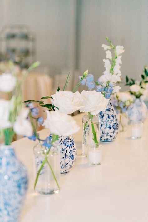 Classic Southern White and Blue Wedding Reception with Chinoiserie China Vases and Simple White Floral Centerpieces Blue And White Chinoiserie Vases, Dusty Blue Bud Vases Wedding, Blue And White Faux Flowers, Blue And White Wedding Theme Receptions, Wedding Reception Blue And White, Blue And White Pottery Wedding, Blue And White Bud Vases Wedding, Blue Weddings Ideas, Wedding Florals Peonies