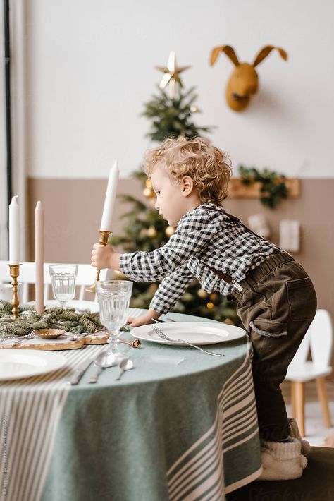 Side view of funny child holding candle near table with dishes, cutlery and glasses in decorated room with Christmas tree Plates And Cutlery, Christmas Instagram Pictures, Gingerbread Cottage, Decorated Room, Holding Candle, Xmas Photos, Mini Outfit, Christmas Shoot, Christmas Mini Sessions