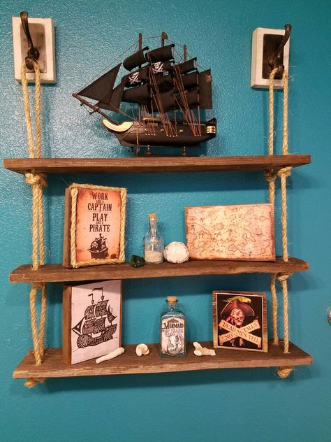 Used old fence boards and some rope I bought to create this cute shelf for pirate bathroom theme Captains Quarters Decor, Pirates Room Decor, Pirate Core Decor, Fish Theme Room, Ship Themed Bedroom, Pirate Aesthetic Home Decor, Pirates Of The Caribbean Bathroom, Pirate Bathroom Ideas, Pirate Aesthetic Bedroom