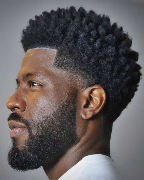 Black men's grown out, medium length shaped afro with low taper fade. This hairstyle first appeared in the article: Low Taper Fade Haircut: What It Is & The Best Styles For 2022, on MensFlair.com Black Fade Haircut, Black Hair Fade, Taper Fade Afro, Afro Fade Haircut, Afro Hair Fade, 2022 Hairstyles, Low Taper Fade Haircut, Fade Haircut Styles, Afro Hairstyles Men