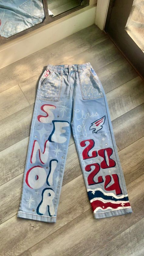 Senior Jeans Soccer, Hoco School Spirit Day, Sr Painted Jeans, Class Of 2024 Jean Ideas, Senior Jeans With Fringe, Decorated Senior Jeans, Grad Coveralls Ideas, Decision Day Jeans, Class Of 2024 Ideas