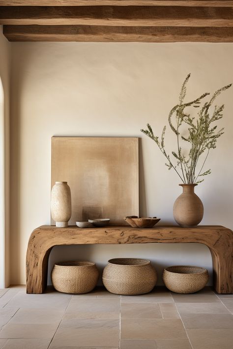 Discover curated charm in our entryway oasis, adorned with a rustic wooden console table, decorative baskets, and minimalist ceramics. Embracing the essence of southern countryside living, this space weaves earthy tones, emotive lighting, and the quaint allure of cottagecore. #CuratedCharm #RusticEntryway #SouthernAppeal #MinimalistDecor #CottagecoreInspiration #EarthTonePalette #DecorativeStools #EmotiveLighting #CountryLiving #HomeDesign Entryway Organic Modern, Organic Earthy Interiors, Rustic Organic Home Decor, Modern Organic Entryway Ideas, Boho Natural Living Room, Organic Modern Entry, Organic Design Interior, Earthy Tones Interior, Modern Organic Entryway