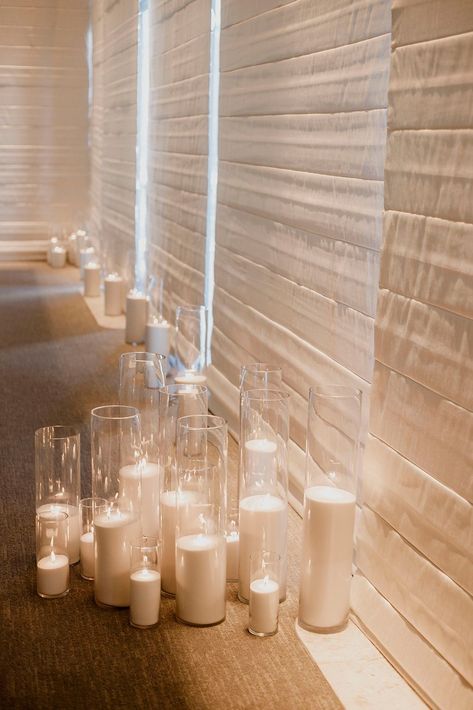 Candles On The Floor Wedding, Floor Candles Living Room, Enclosed Candles Wedding, Candle Entrance, White Pillar Candles Wedding, Wedding Florals And Candles, Pillar Candle Wedding, Floor Candles Wedding, Candle Heavy Wedding Reception