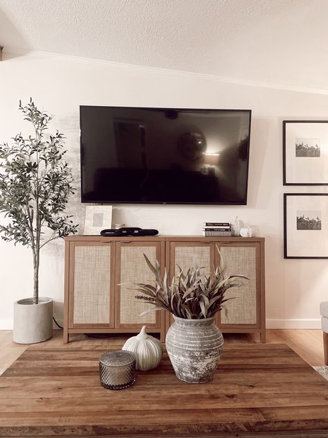 Tv On Wall Decor Ideas, Under Television Decor, 65” Tv On Wall, Minimal Tv Stand Decor, Trendy Tv Stand, Living Room Wall Decor Sides Of Tv, Tv Buffet Decor, Tv Table Styling, Modern Organic Living Room Tv