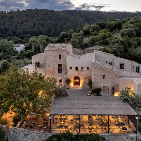 A roughly-hewn stone trough and a traditional mill for pressing olive oil were repurposed as decorative features inside this farmhouse-turned-hotel, set against the backdrop of Mallorca's Serra de Tramuntana mountain range. Lodge Hotel, Grill Restaurant, Small Luxury Hotels, Old Farmhouse, Balearic Islands, The Ranch, Places Around The World, World Heritage Sites, Best Hotels