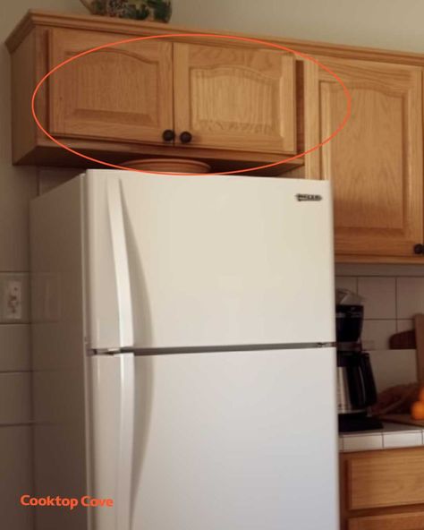 Most people think these cupboards are pointless. Here's how to properly use them Top Of Cupboard Storage, How To Arrange Kitchen Cupboards, Cupboard Above Fridge Ideas, Storing Dishes In Cabinets, Cupboards Above Fridge, Cabinets Above Refrigerator Ideas, Cupboard Over Fridge, Over Fridge Cabinet Organization, How To Store Cups In Cabinets