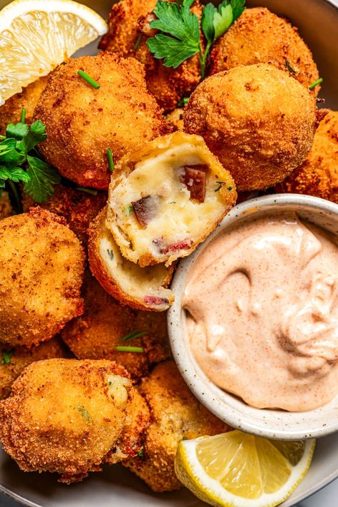 These potato croquettes are out of this world! They're made of bacon-cheddar mashed potatoes formed into balls, coated with breadcrumbs, fried to crispy golden brown, and served with garlic aioli. Late Night Wedding Food Ideas, Mini Potato Appetizers, Potato Hors D’oeuvres, Potato Croquettes Recipe, Fried Potato Balls, Potato Croquette Recipe, Cheddar Mashed Potatoes, Croquettes Recipe, Potato Appetizers