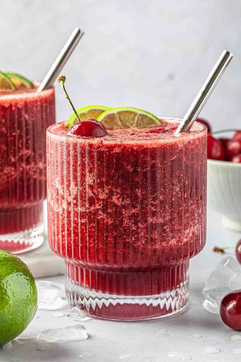 Bursting with bold cherry and zesty lime flavors, this frozen cherry limeade is the best way to cool down on a hot summer afternoon, and it's fun for the whole family. Feel free to spike it with some vodka for the grown ups, or serve it as-is for a refreshing mocktail that everyone can enjoy. Cherry Drink Recipes, Cherry Mocktail Non Alcoholic, Cherry Limeade Mocktail, Cherry Lemonade Cocktail, Cherry Limeade Cocktail, Boozy Cherry Limeade, Cherry Limeade Recipe, Refreshing Mocktail, Cherry Drink