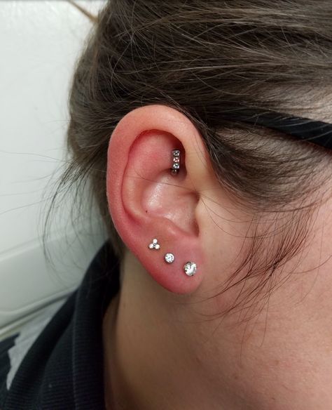 3 earlobe piercing with 4mm prong, 3mm bezel and trinity ends all with CZs. Rook piercing with channel set curved barbell 4 Earlobe Piercings, 3 Earlobe Piercings, Earlobe Piercings, Baby Life, Channel Set, Ear Piercings, Crochet Projects, Diamond Earrings, Piercings