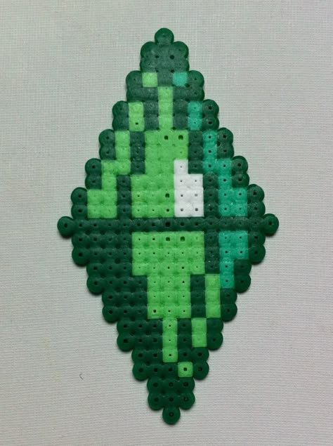 The Sims - Plumbob. (or Green Diamond) But yes, apparently its official name is a Plumbob. Yes, it is weird. Created from hama beads Green Perler Bead Ideas, Sims Pixel Art, Perler Bead Diamond, Sims Cross Stitch, Weird Perler Bead Patterns, Melty Bead Designs, 3d Perler Bead, Easy Perler Bead Patterns, Perler Creations