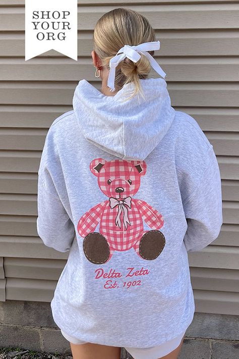 Available in 2XL - 3XL (Click Here) Product ColorAsh Product Details Gildan 18500 50/50 cotton/polyester Product Description Elevate your sorority wardrobe with our Plaid Teddy Sorority Hoodie. Crafted from the softest fabric, this hoodie provides ultimate comfort and style, making it a staple year round. Embrace the perfect blend of warmth and breathability with this must-have addition to your collection About the Design Featuring a trending design, our lightweight hoodie is adorned with an exc Kappa Delta Teddy Bear, Pink Sorority Letters Sweatshirt, Back Of Sweatshirt Designs, Sorority Hoodie Design, Phi Mu Merch, Sorority Christmas Shirts, Sorority Exec Sweatshirts, Sorority Parents Weekend Shirts, Delta Zeta Merch