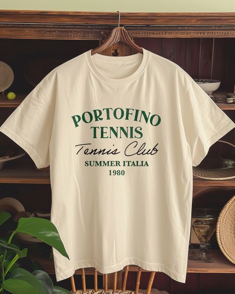 Match point or photoshoot spot? At @thepalms_club, it's always both. 🎾⛰️ Score some style points with our tees and make every game set, match, and snapshot-worthy. #GameSetMatchPhoto . . . . #VintageTee#RetroFashion#PortofinoStyle#TennisClubChic#1980sVintage#ItalianSummer#GraphicTees#EtsyFinds#ShopSmallBusiness#EtsyTShirt#CasualChic#FashionThrowback#SustainableStyle#EtsyShopOwner Italy Graphic, Portofino Italy, Graphic Tee Vintage, Vintage Tennis, Retro Sports, Tennis Club, Tennis Clubs, Graphic Tees Vintage, Selling Clothes