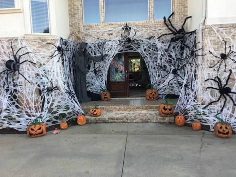 Spiders Decorations Halloween, Cheesecloth Spider Web Diy, Beef Netting Spider Web Diy, Diy Spider Webs Outdoor, Halloween Decor Spider Web, Spider Web House Decoration, Spider Wall Halloween, Front Porch Halloween Decor Spider Web, Big Spider Web Decoration