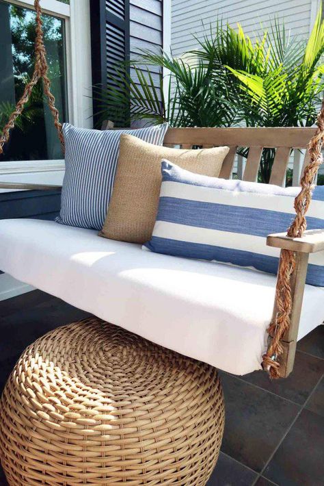 Coastal front porch makeover with driftwood gray swing, with the chain wrapped in rope. Sun washed blues, sandy textures, and palms that wave in the breeze give you that sand in your toes feeling. Coastal living right in town. #coastaldecor #coastalchic #frontporch #porchideas #patioideas Florida Front Porch Ideas, Coastal Porch Ideas, Coastal Front Porch, Sunroom Layout, Coastal Porch, Farmhouse Porch Swings, Porch Refresh, Beach Porch, Front Porch Makeover