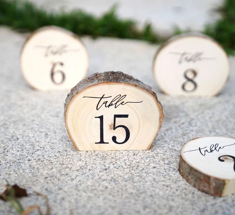 PRICES MAY VARY. Want to have something different and unique for your wedding?! These engraved aspen wood standing slices stand up on each table and have a nice rustic feeling touch to them. Each piece is unique as there will never be two of the same wood slice. Size:Diameter: 4" inches (approximate); Thickness: 3/4-1" inches (approximate). These tree slices are cut on bottom edge and then engraved for a great table decoration. Use them at your cake table, guest book table, or on each table at y Wood Rounds For Centerpieces, Lotr Table Numbers, Pumpkin Table Numbers Wedding, Simple Fall Centerpieces Wedding, Wood Wedding Centerpieces, Woodsy Wedding Decor, Wood Table Setting, Western Wedding Decor, Wooden Wedding Decor