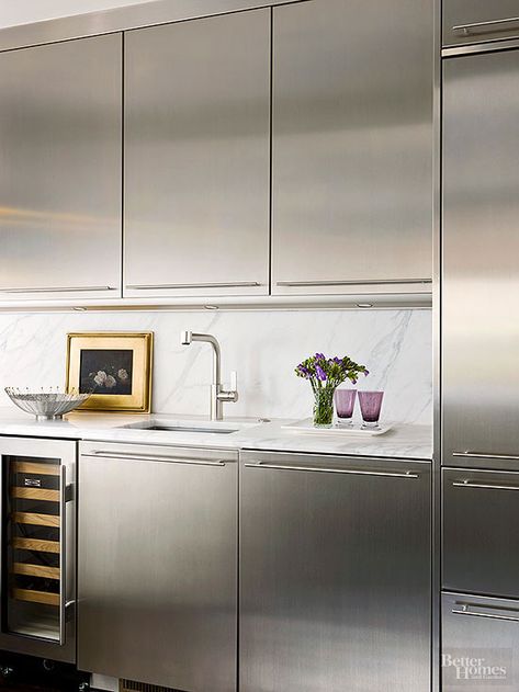 Tucked away in a butler's pantry, this sleek wet bar displays a modern twist on traditional thanks to gorgeous marble countertops and stainless-steel cabinetry. The work area provides a hidden prep space and houses an extra refrigerator and wine cooler. Marble And Stainless Steel Kitchen, Stainless Steel Kitchen Design, Grey Kitchen Interior, Metallic Kitchen, Wet Bar Ideas, Contemporary Kitchen Interior, Wet Kitchen, Stainless Steel Kitchen Cabinets, Steel Kitchen Cabinets