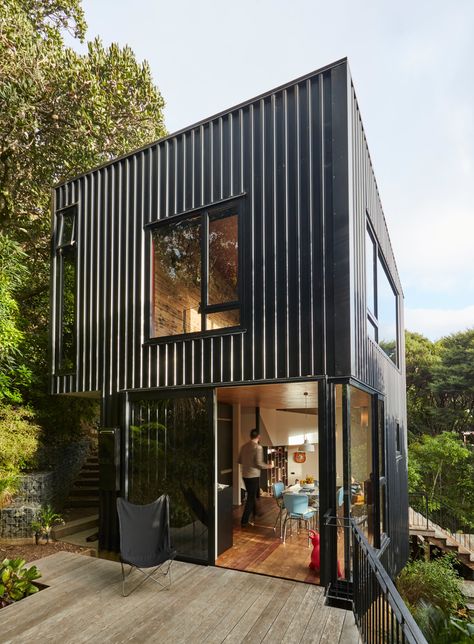 A concrete slab at the entry transitions to a staircase of recycled tawa. Black Houses, Casa Container, Minimal Home, Container House Design, Concrete Slab, Shipping Container Homes, Blackpool, Metal Buildings, Small Home