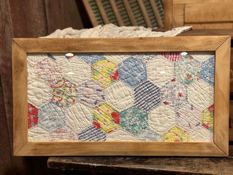 This sweet vintage quilt is framed in a repurposed wood frame. the original quilt was too damaged to repair, so I framed it so this treasure can still be enjoyed. The quilt is made with colorful and delicate fabric. This piece comes ready to hang, with hardware on back. Glass in place in front of quilt. This piece would make a beautiful gift or addition to any home! Quilt Wall Decor, Vintage Quilt Coasters, Framed Quilts Wall Hangings, How To Hang Quilts On Wall, Old Fabric Diy Reuse, How To Display Quilts In Your Home, Quilt Repurpose Ideas, Vintage Quilt Crafts, What To Do With Old Quilts