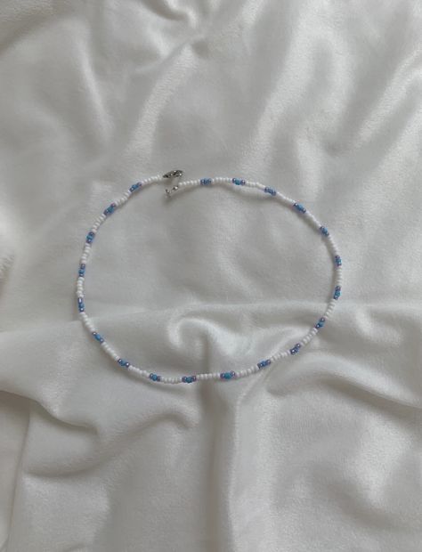 This necklace is made of a white, blue and purple seed beads with a clasp. The beads are small for a cute minimalist look while still having a sophisticated and preppy look. They really fit in with the outer banks style which is so trendy at the moment! It can be styled with so many pieces to make any outfit really cute and trendy. This vsco style is so popular at the moment and this necklace is the perfect fit for that! Something that kiara from outer banks might wear! Gift for him, gift for he How To Make A Cute Necklace, Blue Beaded Necklace Ideas, Small Beaded Jewelry, Outer Banks Jewelry Ideas, Minimalist Beaded Necklace, Minimalist Beaded Jewelry, Small Bead Necklace Ideas, Making Necklaces With Beads, Cute Necklaces To Make