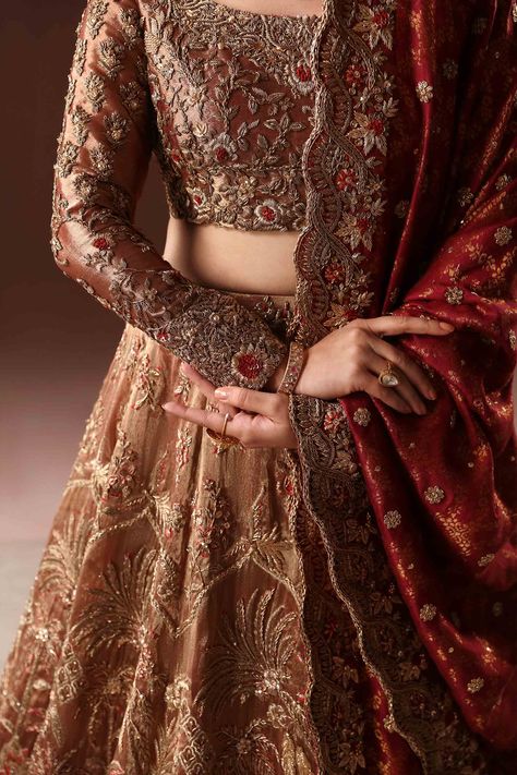 Royal Rusted Gold Embroidered Pakistani Bridal Dress Lehenga choli rafted flora and fauna cover the lehnga with intricate zardozi work with touches of rust resham. Hints of gilded golden 'succha' gota add further beauty to this regal design. Detailed Description: SKU: BB301 Detailing: Embroidery, Motifs, Naqshi, Sequins, Dabka, Zari Color: Rusted Gold Fabric: Jamawar, Tissue, Crimson Chiffon Design: Fully Embellished Dress with Embroidery Event: Bridal wear, Wedding Latest Lehnga Designs, Golden Bridal Lehenga, Lehenga Designs Latest, Dress Lehenga, Pakistani Bridal Lehenga, Latest Bridal Lehenga Designs, Rust Color Dress, Pakistani Bridal Dress, Red Bridal Dress