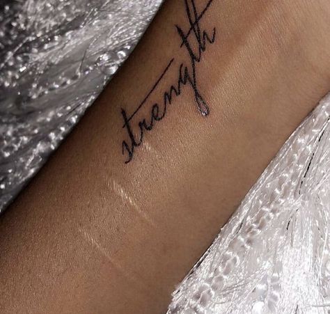 Strength Cursive Tattoo, Arm Tattoo Words Writing, Keep Going Quotes Tattoo, Strength Wrist Tattoos For Women, Word Strength Tattoo, Strength Word Tattoo, Collarbone Word Tattoo, Arm Word Tattoos For Women, You Are Loved Tattoo