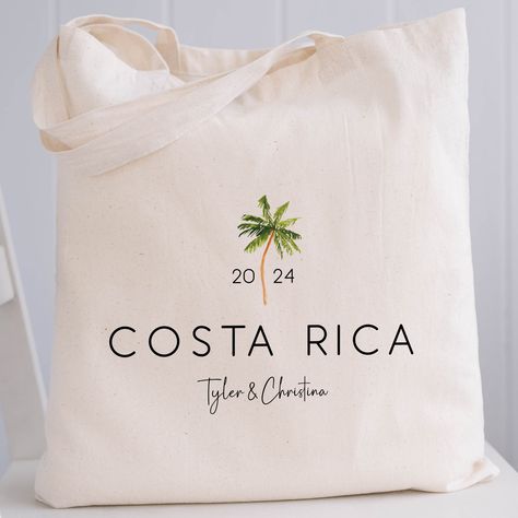 These palm tree print canvas tote bags are a fun way to celebrate a destination wedding, vacation, or other special event. Choose our roomy, gusseted tote bags with handles in our economy or premium heavy canvas style, our canvas drawstring backpacks, or one of 3 sizes of our popular drawstring canvas bags. Customize your bags with the year, your destination, and 1 line of text. 𝝗𝗨𝗟𝗞 𝗣𝗥𝝞𝗖𝝞𝝢𝗚 Scroll down for tips on bulk pricing and how to place your order.  𝗣𝗘𝗥𝗦𝗢𝗡𝗔𝗟𝗜𝗭𝗘 𝗬𝗢 Key West Welcome Bags, Tropical Favors For Guests, Destination Wedding Goodie Bags, Gift Bags For Wedding Guests At Hotel, Destination Wedding Gift Bags, Welcome Bags For Wedding Guests, Destination Wedding Welcome Bags, Palm Tree Wedding, Wedding Goodie Bags