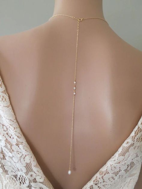 This exquisitely detailed pearl drop bridal necklace with its long stylish backdrop will bring an elegant touch to your low V wedding gown. Crystal pearls and rhinestones cluster together to form the focal of this lariat style necklace. The finishing touch is a dainty embellished freshwater pearl that sways gently at the end of a delicate gold chain bringing hints of romance and vintage nostalgia. Pearl Backdrop, Long Drop Necklace, Lariat Style Necklace, Delicate Gold Chain, Vintage Nostalgia, Backdrops Necklace, Back Necklace, Necklace Pearl, Necklace Long