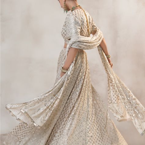 This beautiful lehenga is made of Silk Georgette fabric, adorned with Rosegold mukaish work and Chikan Kari embroidery. The classic off-white base color is perfectly complemented by the heavy mukaish handwork. The blouse is complete with full mukaish embroidery, and the set comes with a silk Georgette dupatta featuring heavy mukaish work as well. #LehengaLove #MukaishMagic #ChikanKari #SilkGeorgette #RosegoldElegance #RichaAhluwalia #festivewear #bridalcouture #handcraftedclothing #indianwedd... Silk Dupatta, Georgette Fabric, Bridal Couture, Fashion Stylist, Festival Wear, Base Colour, Timeless Beauty, Lehenga, Off White