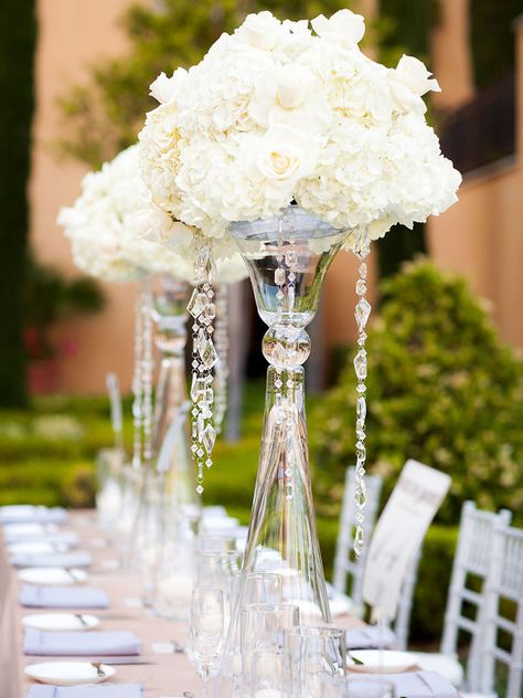 It’s time to take your wedding centerpieces up a notch with decadent sparkles, beaded embellishments and towering vases. Take a look at these 13 glamorous centerpieces with serious bling. Bling Centerpiece, White Floral Centerpieces, Cinderella Wedding, Wedding Floral Centerpieces, Bling Wedding, Wedding Flower Inspiration, Mod Wedding, Glamorous Wedding, Floral Centerpieces