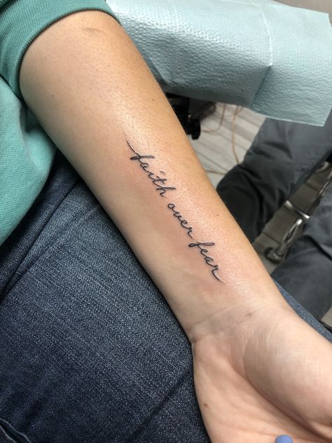 Women Small Wrist Tattoos, Forearm Tattoos Women Small, Small Tattoos Scripture, Faith Bigger Than Fear Tattoo, Montani Semper Liberi Tattoo, Side Forearm Tattoos For Women, Forearm Word Tattoo Women, Forearm Quote Tattoo Women, Arm Quote Tattoos For Women