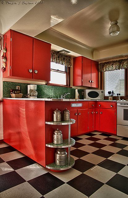 Lovely red kitchen with black-and-white tiled floor... Black White Red Kitchen, Red Retro Kitchen, Black And White Floor Kitchen, Black And Red Kitchen Ideas, Red Cabinets Kitchen, Black White And Red Kitchen, Black And White Tile Kitchen, Green And Red Kitchen, Red Kitchen Design